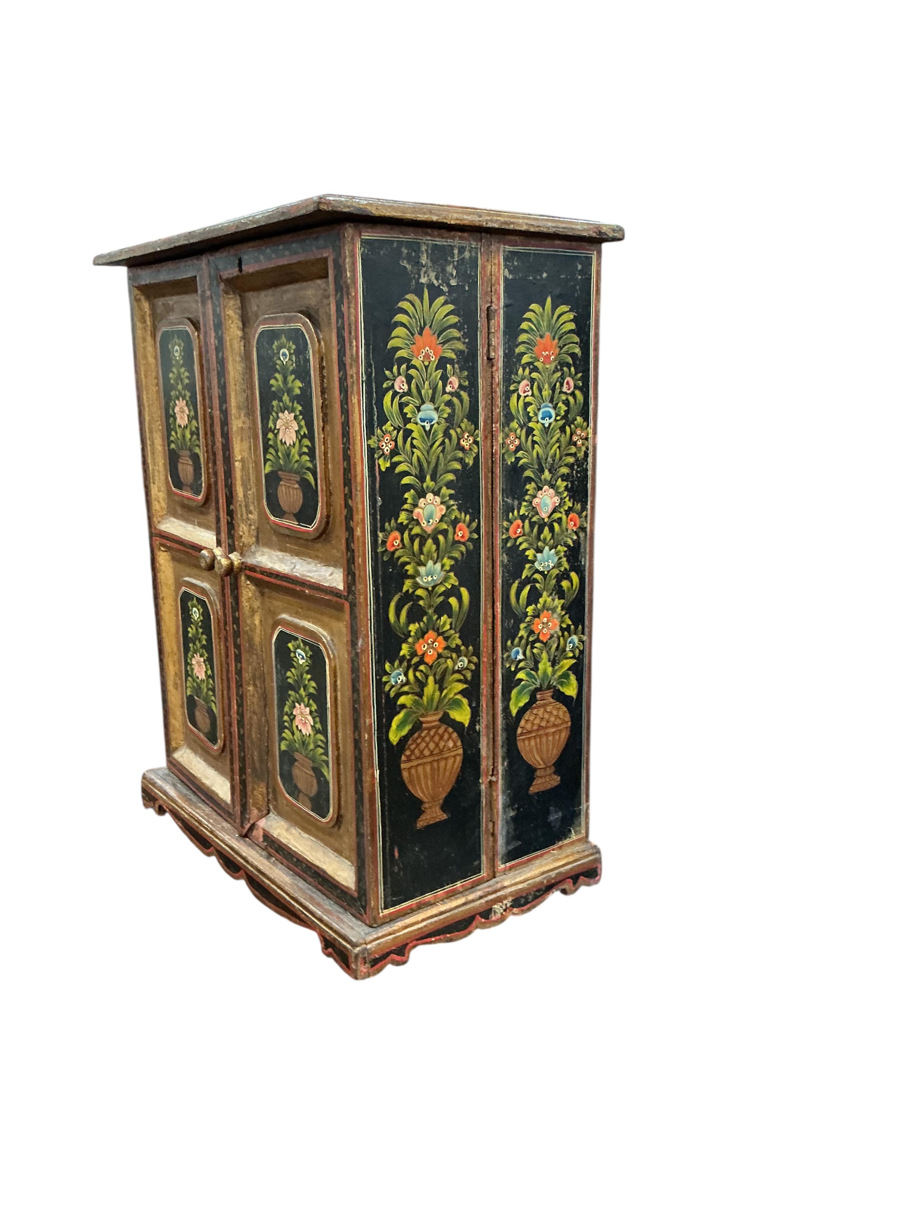 An Indian painted table cabinet, width 46cm, depth 28cm, height 59cm